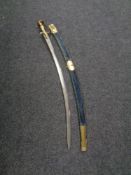 An Indian brass handled sword with scabbard