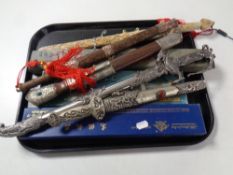 A tray containing a quantity of boxed and unboxed replica oriental and Persian style knives