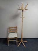 A stripped pine hat and coat stand together with a pine ladder back rush seated kitchen chair