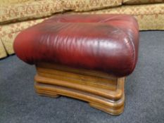 An oak red leather upholstered footstool