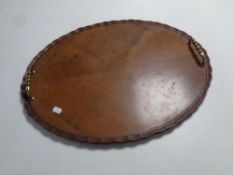 An Edwardian pie crust edge serving tray with brass handles