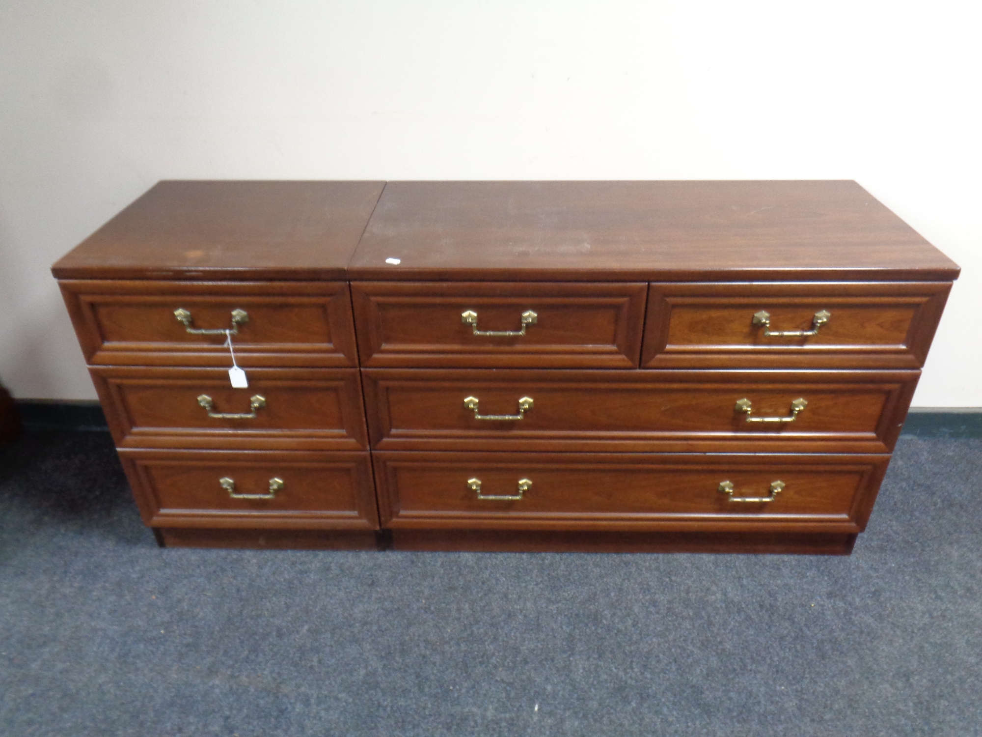 A 20th century G Plan four drawer chest together with three drawer bedside chest in a mahogany