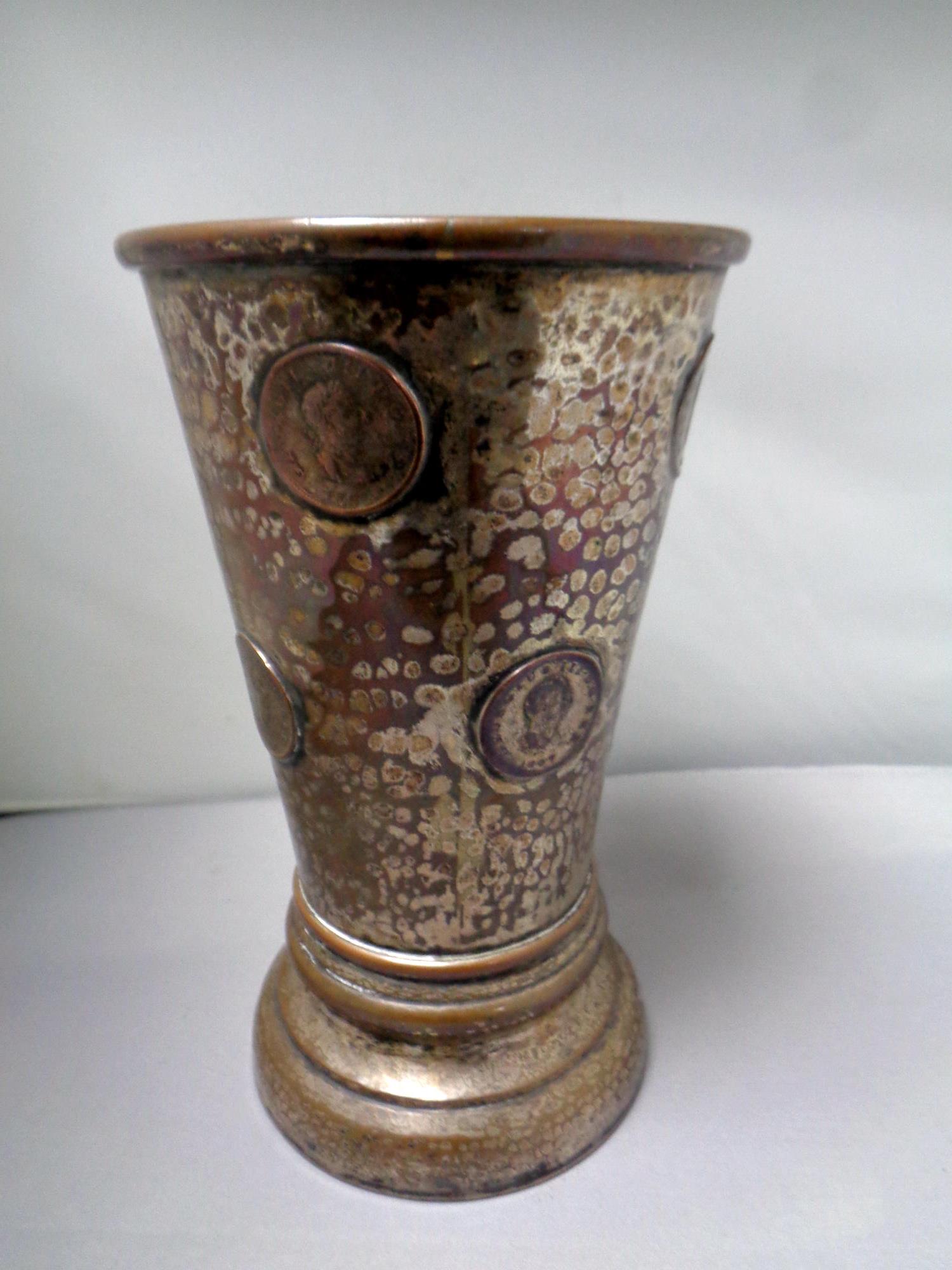 A 19th century copper plated drinking vessel, embossed with George III 1807 coins,