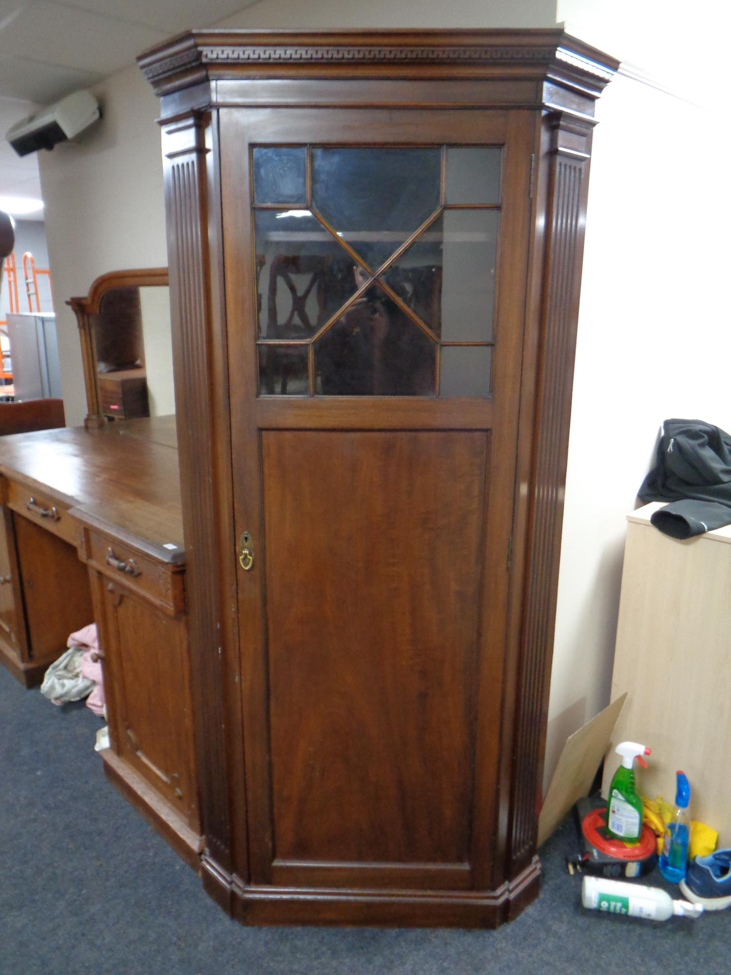 An Edwardian mahogany glazed door corner hall wardrobe fitted with snooker cue rack