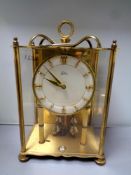 A brass cased Coma anniversary clock with key