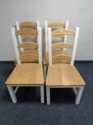 A set of four contemporary pine ladder back dining chairs