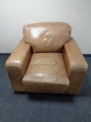 A club armchair upholstered in brown leather