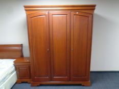 An Olympus Furniture cherry wood triple door wardrobe, 158cm wide by 65cm deep by 199cm high.