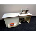 A New Home electric sewing machine in cabinet