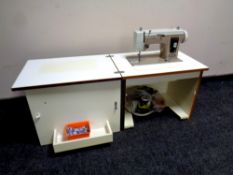 A New Home electric sewing machine in cabinet