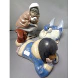 A Nao figure - Inuit child lying with head in hands, matte finish,