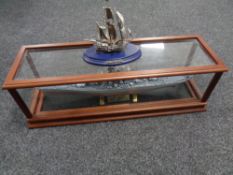 A model USS Missouri in display case together with a further pewter figure of the Golden Hind