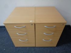 A pair of three drawer under desk chests