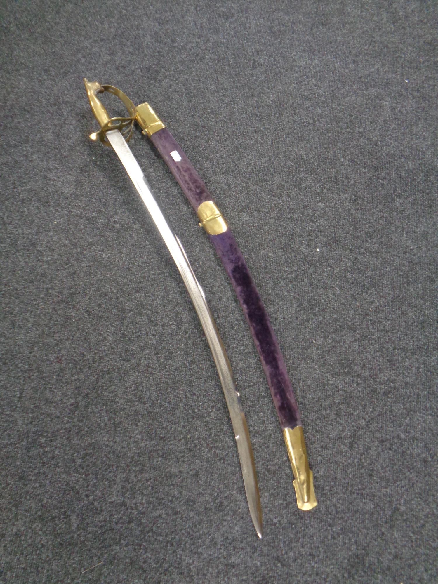 An Indian brass handled sword with scabbard