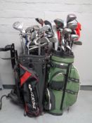 Four golf bags containing a quantity of assorted irons,