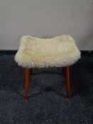 A mid 20th century dressing table stool on teak legs