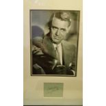 CINEMA, signed album page (3.5 x 3) by Cary Grant, overmounted beneath photo, half-length, 12 x 19.5