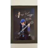 POP MUSIC, AC/DC, signed colour photo by Angus Young, 4 x 6, laid down to card, EX