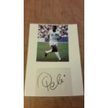 FOOTBALL, signed piece by Pele, laid down beneath colour photo in action for New York Cosmos, 5.25 x