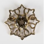 A Scottish 9ct gold and smoky quartz single stone brooch in a pierced openwork design, Edinburgh