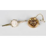 A Victorian gold, garnet and pale blue gem set circular brooch with applied decoration, the back