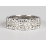 An 18ct white gold and diamond half eternity ring, mounted with a row of princess cut diamonds