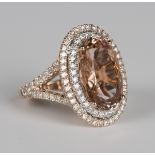 A 14ct rose gold, peach morganite and diamond oval cluster ring, claw set with an oval cut peach