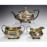 A George III silver three-piece tea set, comprising teapot, cream jug and two-handled sugar bowl,