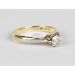 A gold, platinum and diamond single stone ring, claw set with a circular cut diamond, detailed '18ct