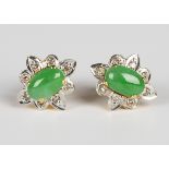 A pair of gold, jade and diamond cluster earrings, each claw set with an oval cabochon jade within a