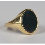 A gold and oval bloodstone signet ring, presentation inscribed within the band, weight 9.7g, ring
