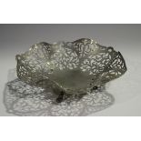 An Elizabeth II silver sweetmeat basket with wavy rim and pierced foliate scroll decoration,