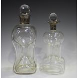 An Edwardian silver mounted clear glass 'Cluck-Cluck' decanter and stopper with silver collar,