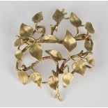 A 9ct gold brooch of circular foliate openwork design, London 1975, weight 9.5g, width 4.5cm.Buyer’s