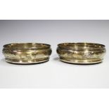 A pair of silver circular wine coasters, each with turned wooden base, London 1972, diameter 14cm.