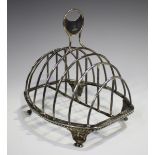 A George III silver six-division toast rack with central circular panel handle above a gadrooned