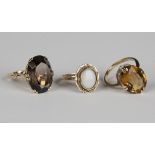 A 9ct gold ring, claw set with an oval cut smoky quartz, ring size approx M, another gold ring, claw