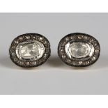 A pair of silver gilt and diamond oval cluster earrings, each mounted with the principal foil backed