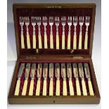 A set of twelve George V silver dessert knives and forks, each with ivory handles, Sheffield 1910 by
