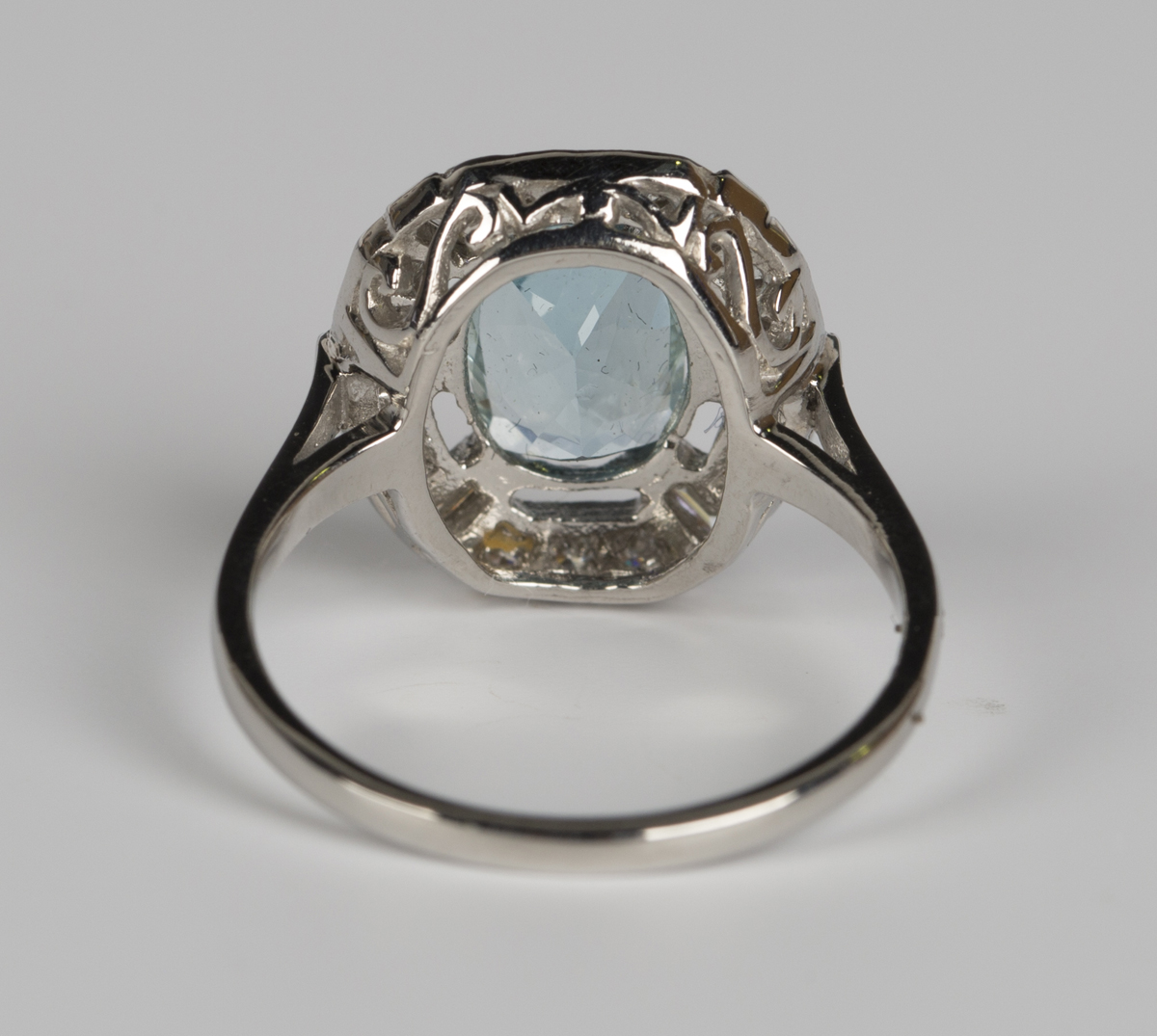 An aquamarine and diamond ring, claw set with an oval cut aquamarine within an openwork surround, - Image 4 of 5