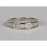 An 18ct white gold and diamond half eternity ring, set with baguette cut diamonds, detailed '750' '