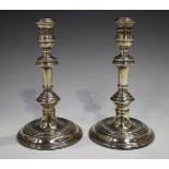 A pair of George I style silver candlesticks with turned knop stems and circular bases, London