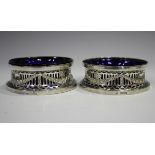 A pair of George V silver diminutive dish rings, each pierced and embossed with festoons, Chester