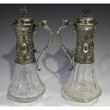 A pair of late 19th century German silver mounted cut glass claret jugs, each tapering faceted