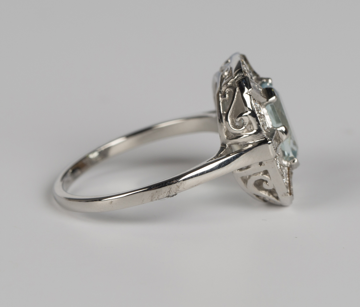 An aquamarine and diamond ring, claw set with an oval cut aquamarine within an openwork surround, - Image 2 of 5