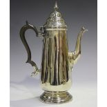 A George V silver coffee pot of tapered cylindrical form with domed hinged lid and urn finial,