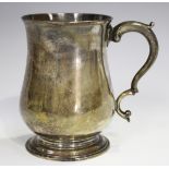 An early George III silver baluster tankard with scroll handle, on a skirted foot, London 1760 by