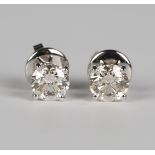 A pair of 18ct white gold and diamond single stone earrings, each claw set with a circular cut