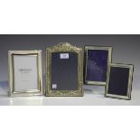 An Elizabeth II silver photograph frame of arched rectangular form, embossed with ribbon bow and