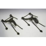 A pair of nickel plated spurs with floral engraved decoration, hung with chains, length 19cm,